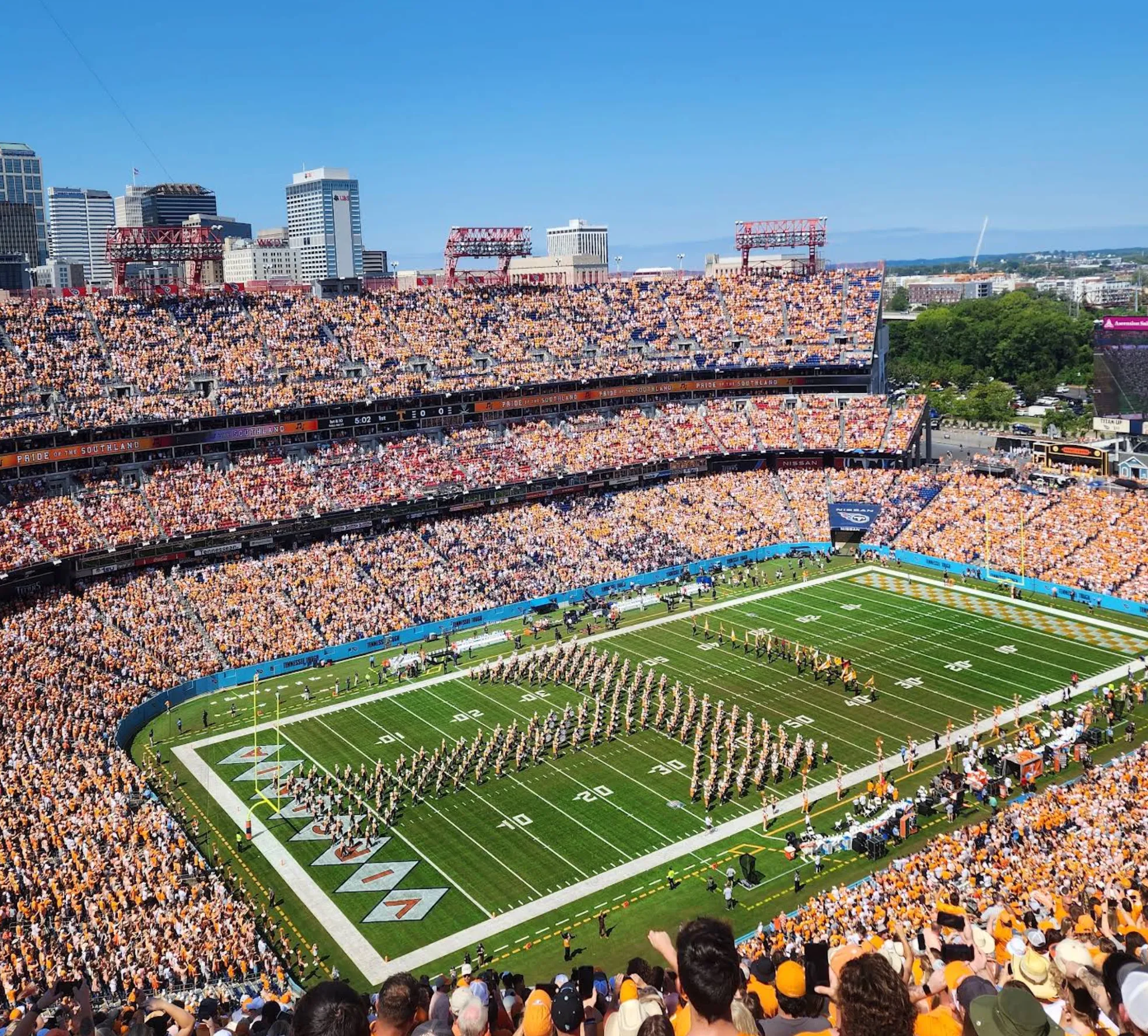 Image: Family in team colors cheering in the stands at a football stadium
