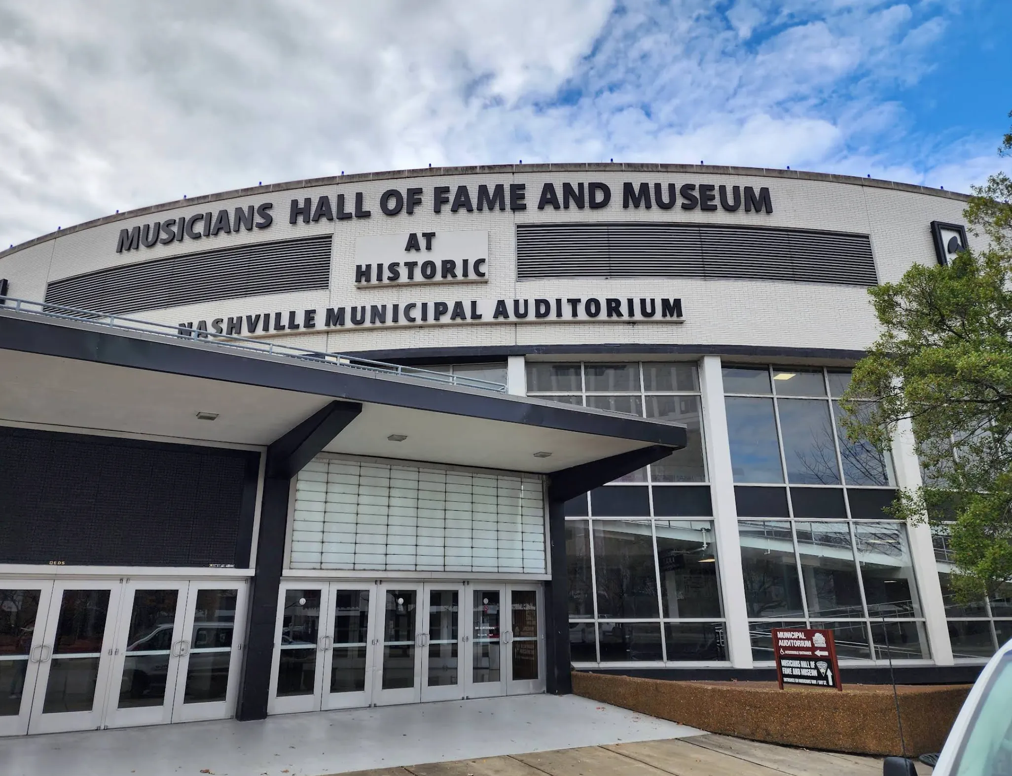 Image: Teenager reading an exhibit about session musicians inside a museum