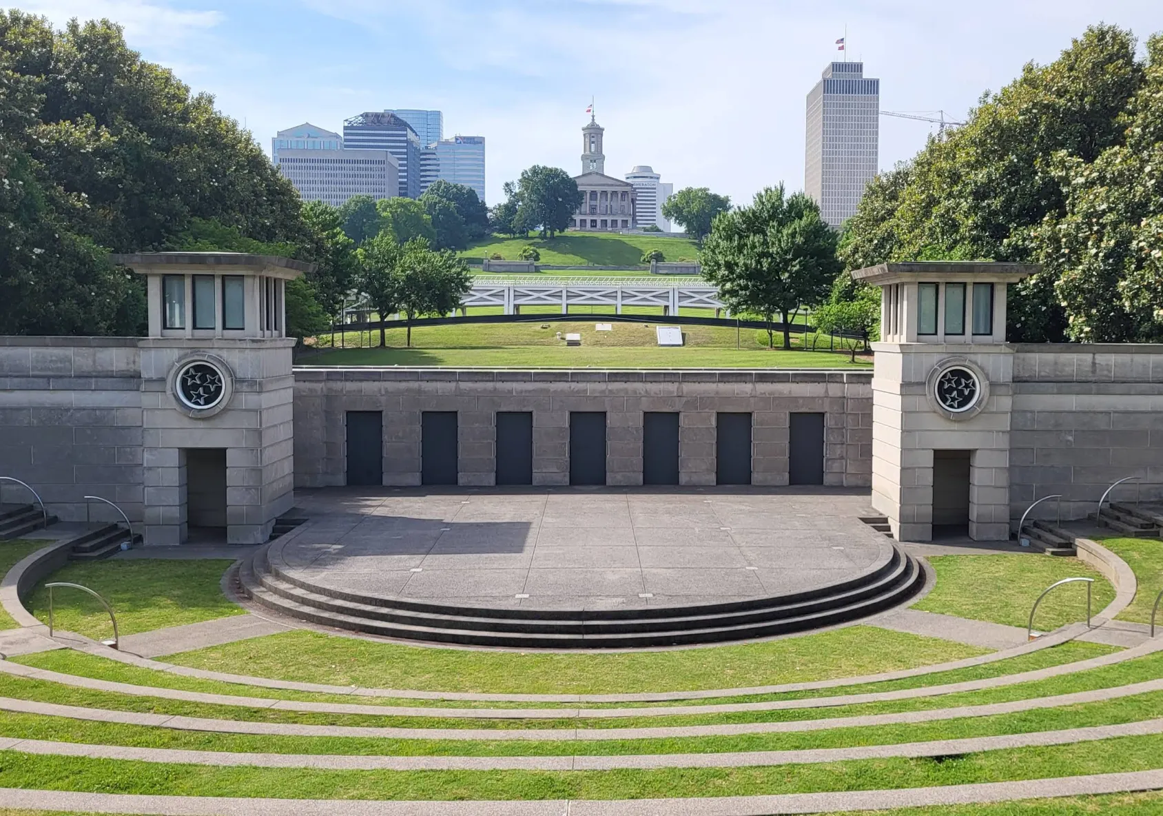 Image: Kids running along a paved path with the Tennessee State Capitol visible in the background
